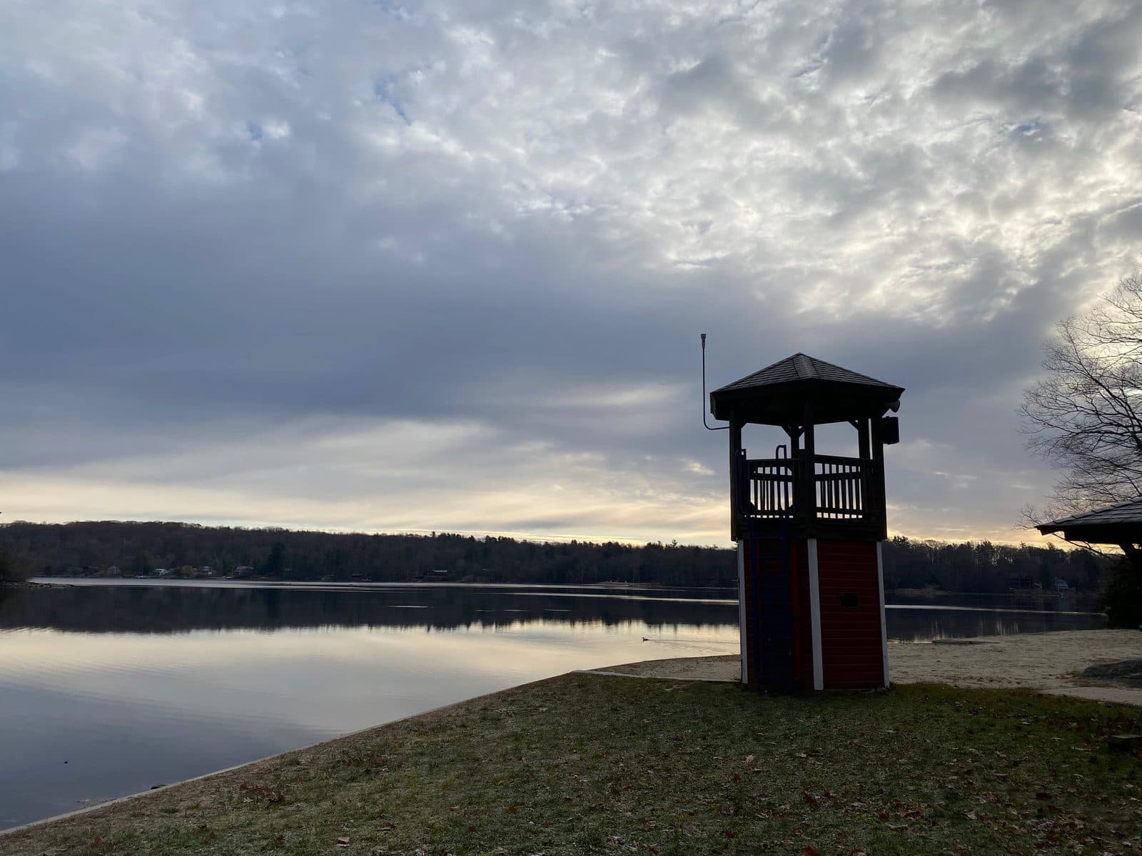 The lookout tower and lake at Camp Sequassen under an evening sky