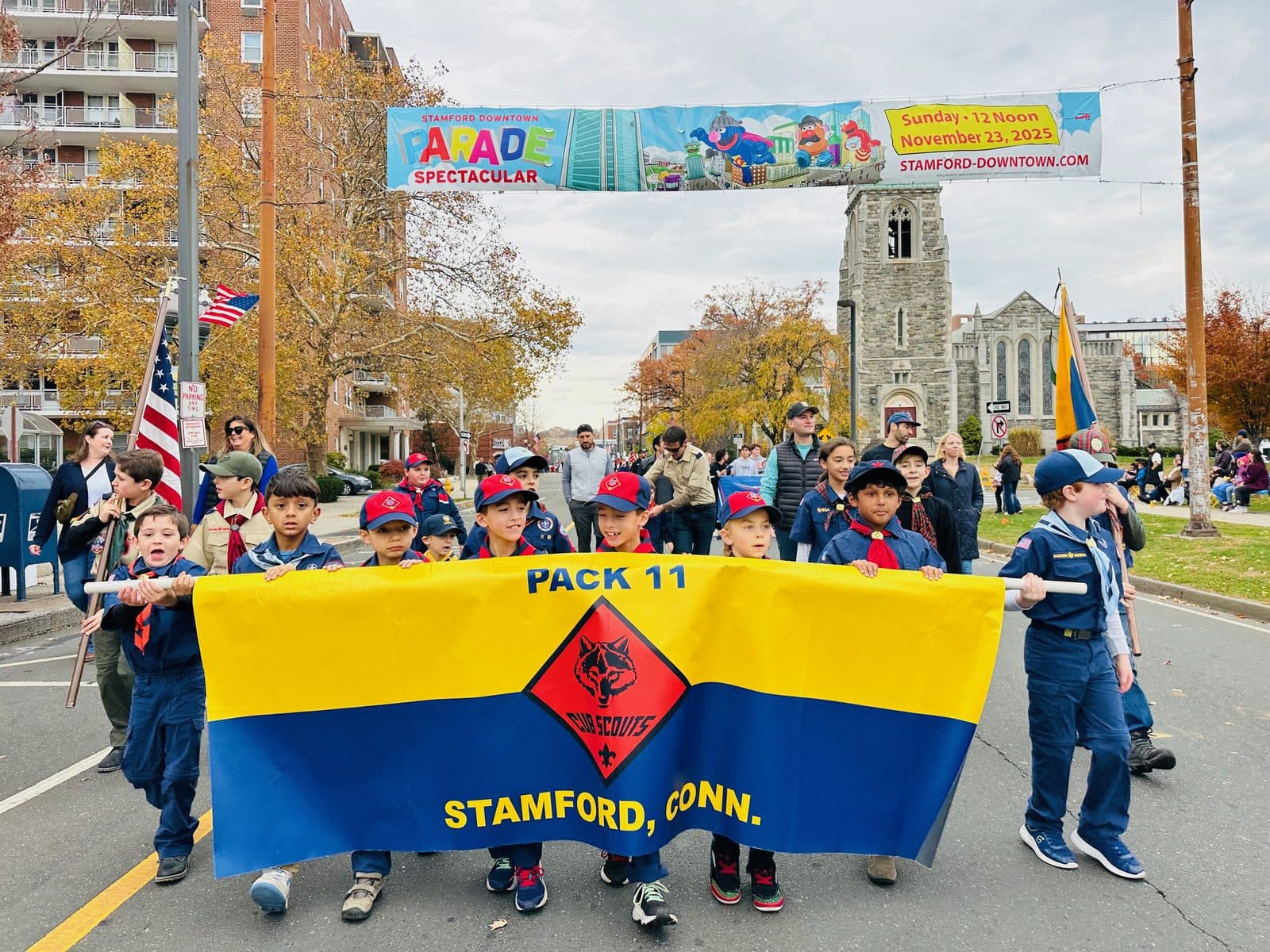 Pack 11 marching behind the pack banner in the Stamford Veterans Day parade